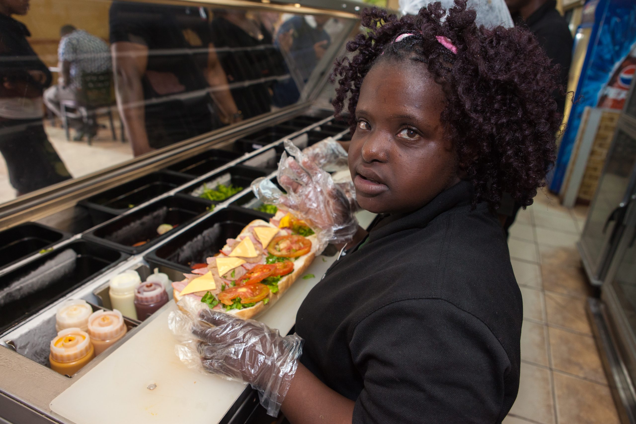 Diana Tembo working in a sandwich store