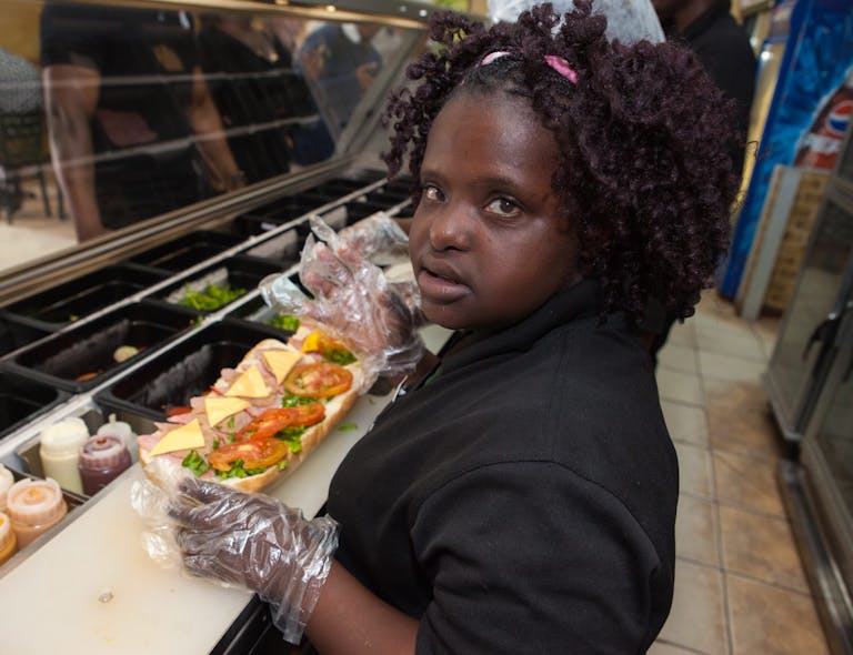 Diana Tembo working in a sandwich store